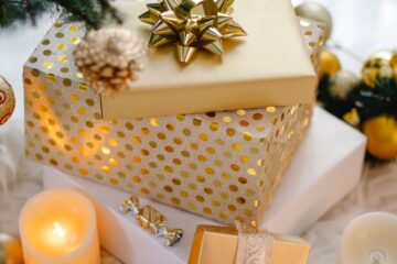 colorful gift boxes and candle under christmas tree