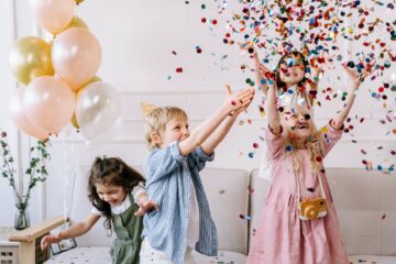 a children playing with confetti in a party